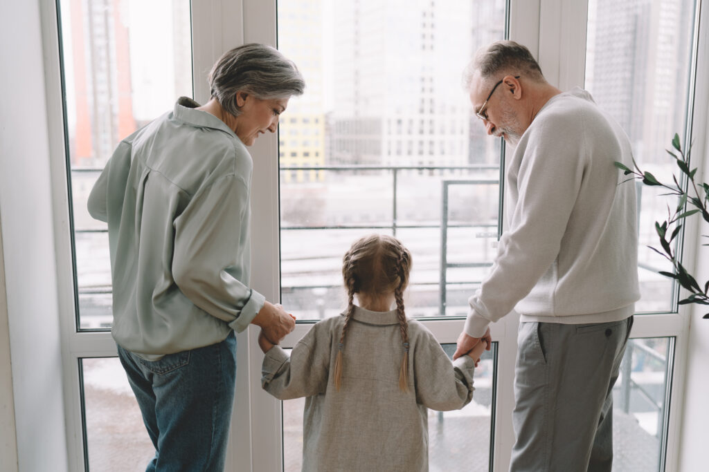Family Law Attorney Laguna Hills helps Senior couple with granddaughter get child support near glass doorway Trevino Law Laguna Hills, CA 92653